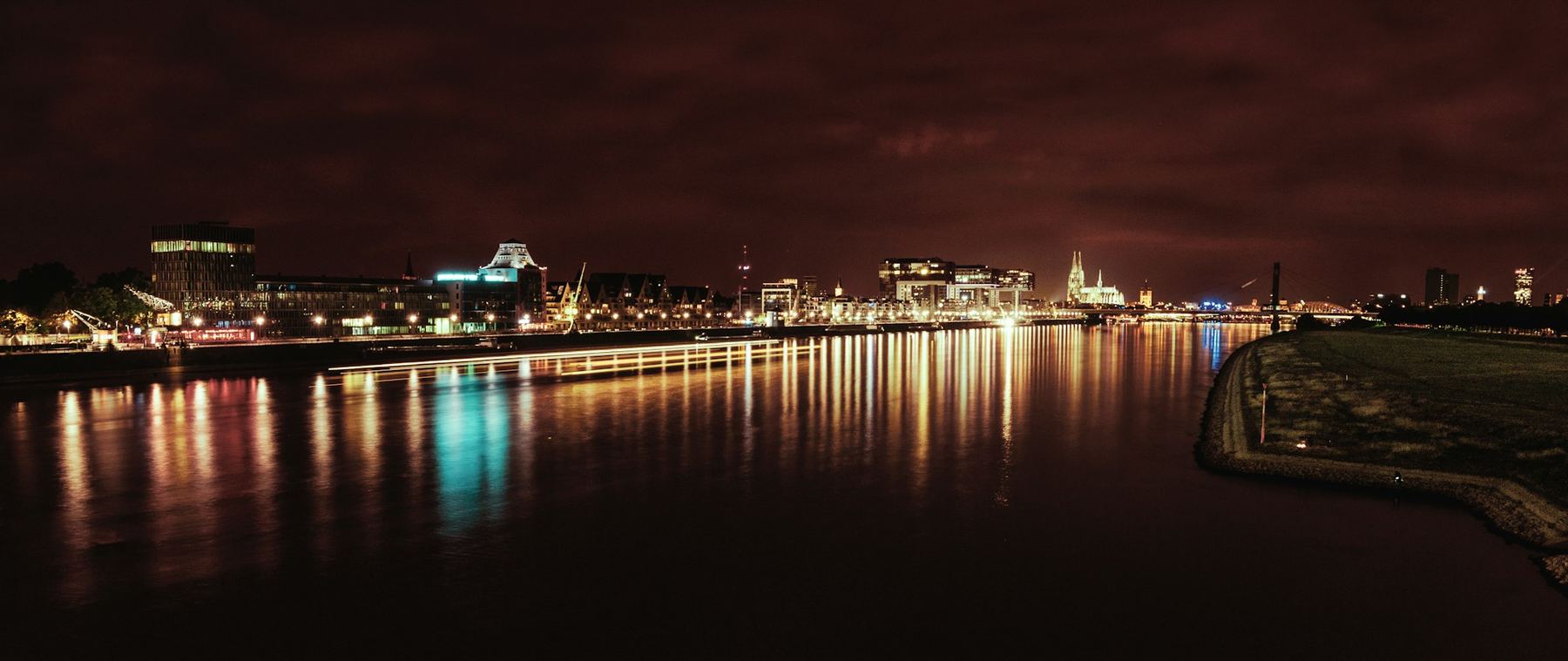 City lights reflected in a river at night